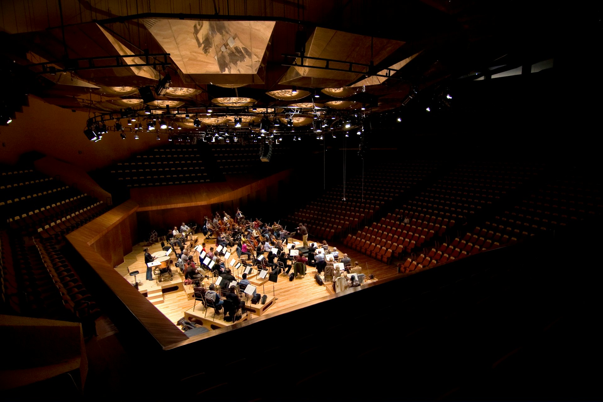 Conducting podium and orchestra in rehearsal